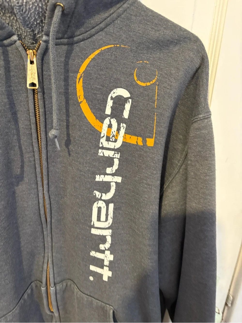 Carhartt Y2K Charcoal Gray Zip-Up Hoodie with Vertical Logo and Orange Accent.